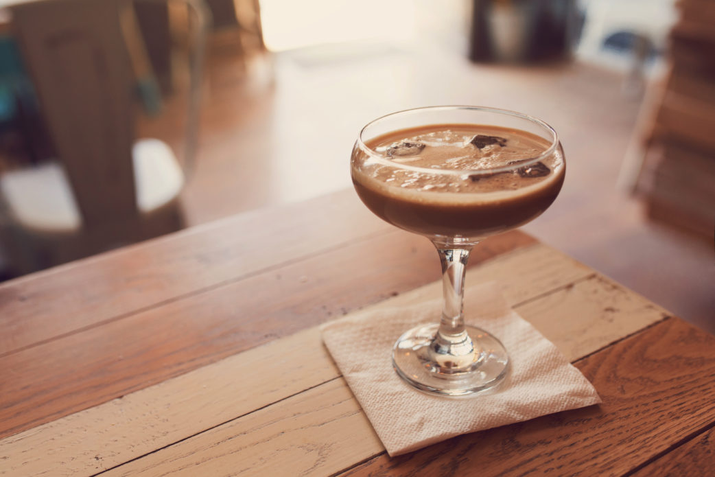 espresso martini in a glass, close-up with blurred background
