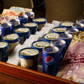 Tubs of ice cream and popcorn on a tray