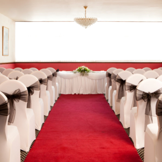 The Ambassador Suite at Mercure Ayr Hotel, set up for a wedding ceremony, red carpet aisle