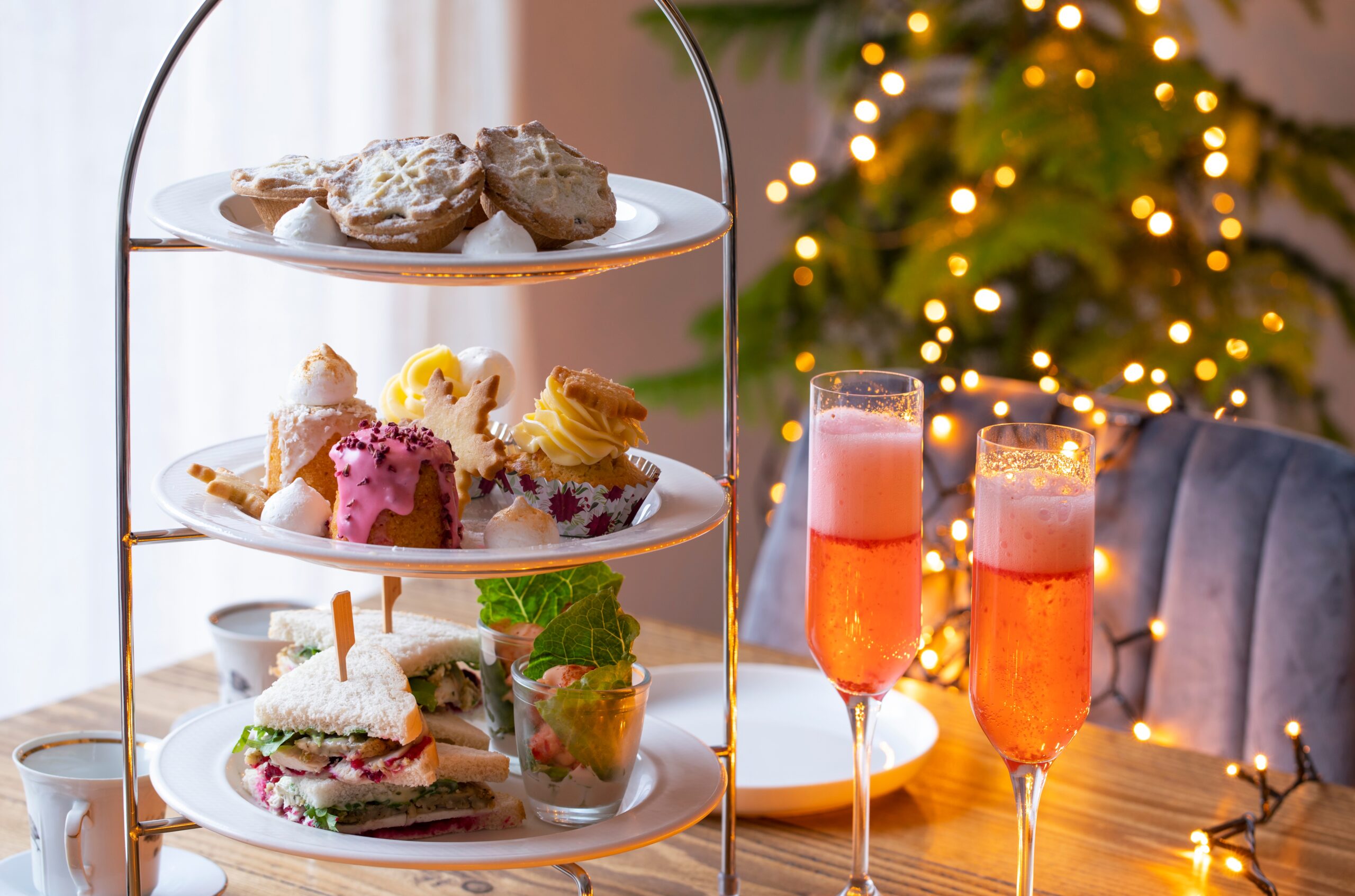 Christmas,Afternoon,Tea,With,Mince,Pies,,Cakes,,Turkey,Sandwiches,And table with wine glasses
